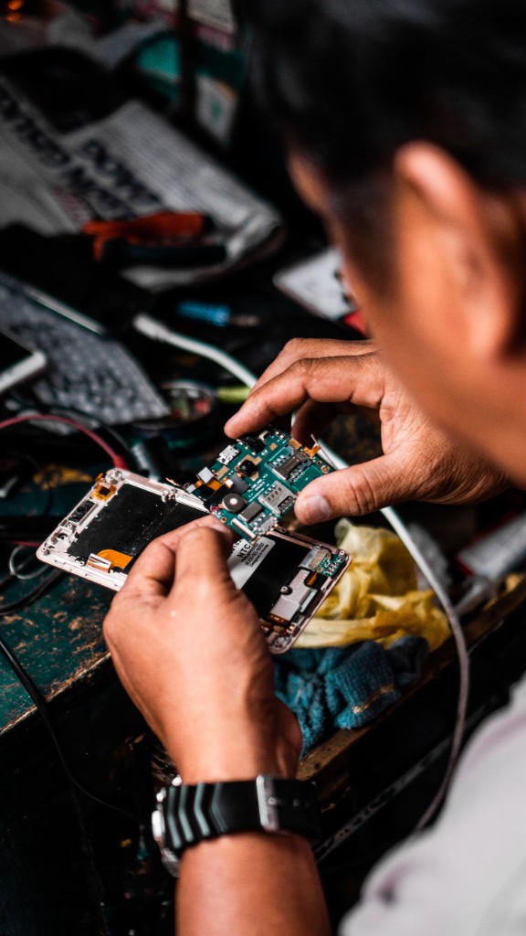 A technician repairing a smartphone